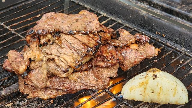 Grilled meat and onion over open flames