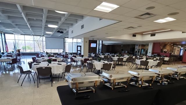Large event hall with a buffet line of chafing dishes