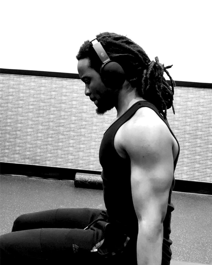 Marx Mumbuwa in the gym, wearing headphones