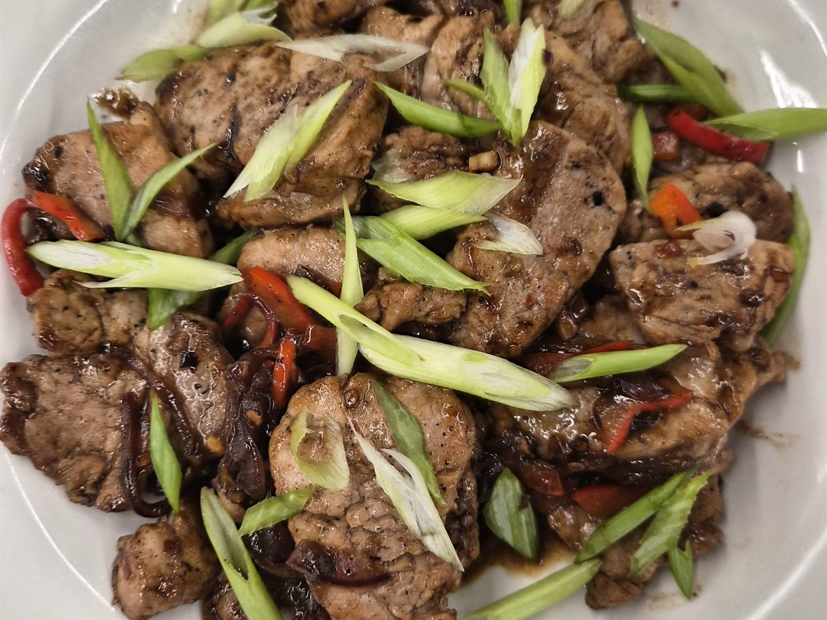 Glazed stir-fry with tender meat, red chili, and fresh scallions